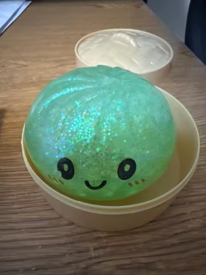 Mint glitter dumpling squishy in its shell